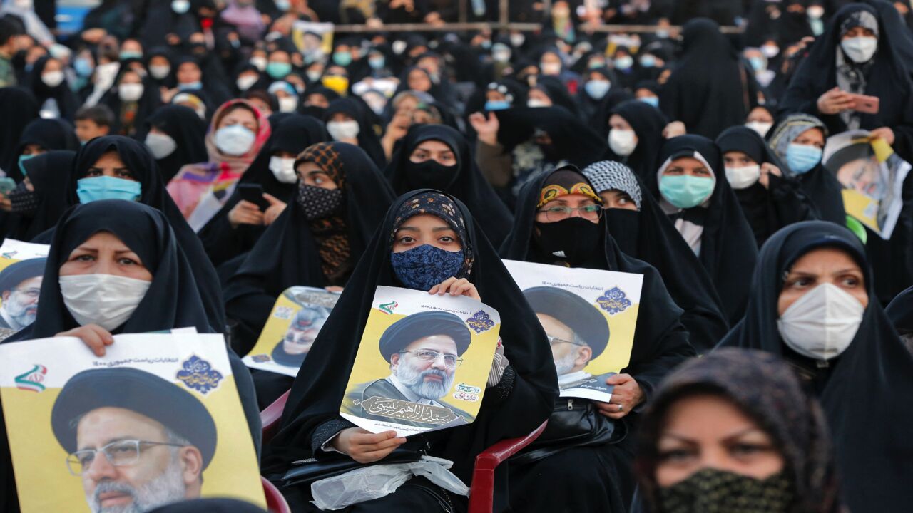 Women supporters of Iranian presidential candidate Ebrahim Raisi hold up his posters during an election campaign rally in the city of Eslamshahr, about 25 kilometers south of the center of the capital, Tehran, on June 6, 2021. The 60-year-old ultra-conservative Raisi, widely seen as the favorite to win the June 18 presidential election, heads the judiciary and is a "hodjatoleslam," one rank below that of ayatollah in the Shiite clerical hierarchy.