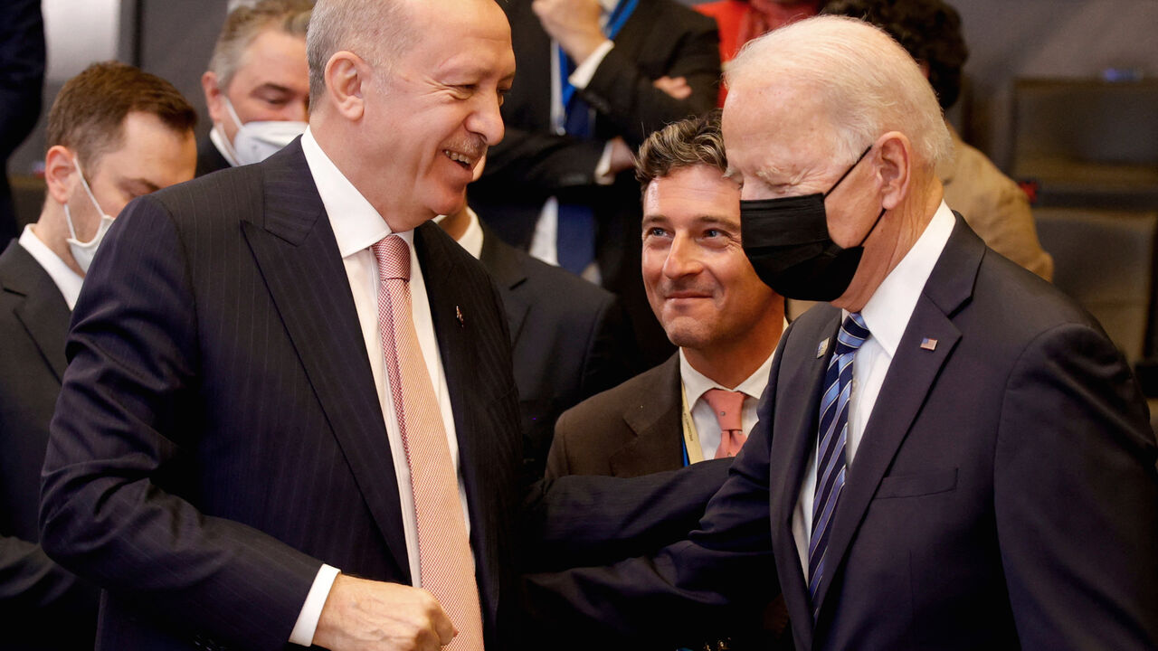 US President Joe Biden (R) speaks with Turkey's President Recep Tayyip Erdogan prior to a plenary session of a NATO summit at the North Atlantic Treaty Organization (NATO) headquarters in Brussels, on June 14, 2021.