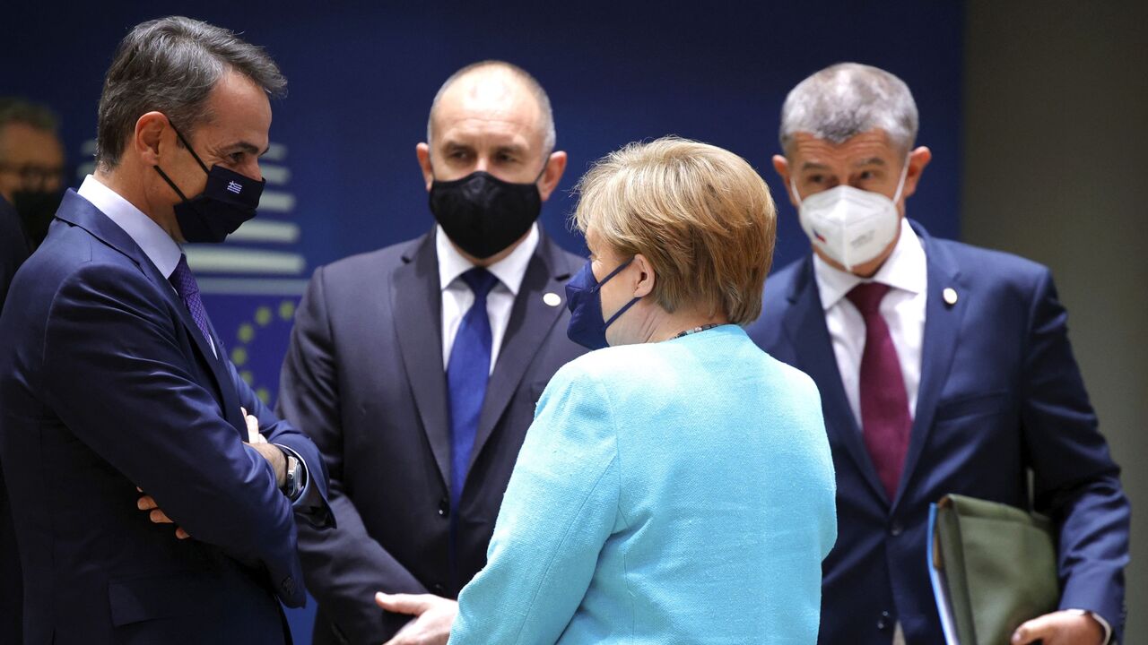 Angela Merkel (2ndR), talks to Greece's Prime Minister Kyriakos Mitsotakis 