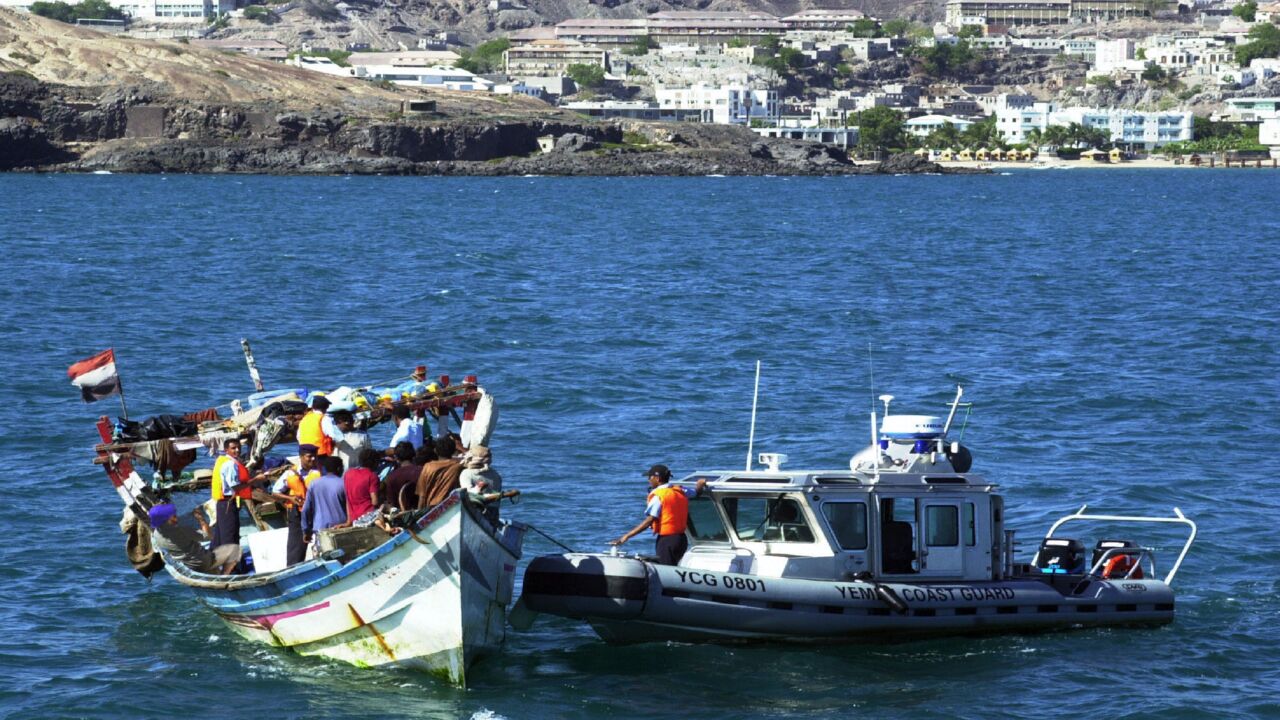 An undated picture shows Yemeni coast guards checking a small boat with refugees arriving from Somalia to the Yemeni port city Aden.