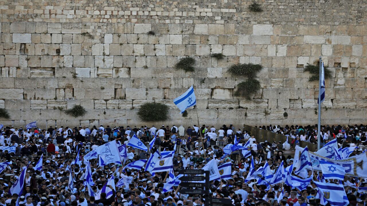 Israeli nationalist settlers wave their national flags at the Western Wall in Jerusalem's Old City on May 13, 2018, as they celebrate Jerusalem Day, an annual celebration of the "reunification" of the city following the 1967 Six-Day War.