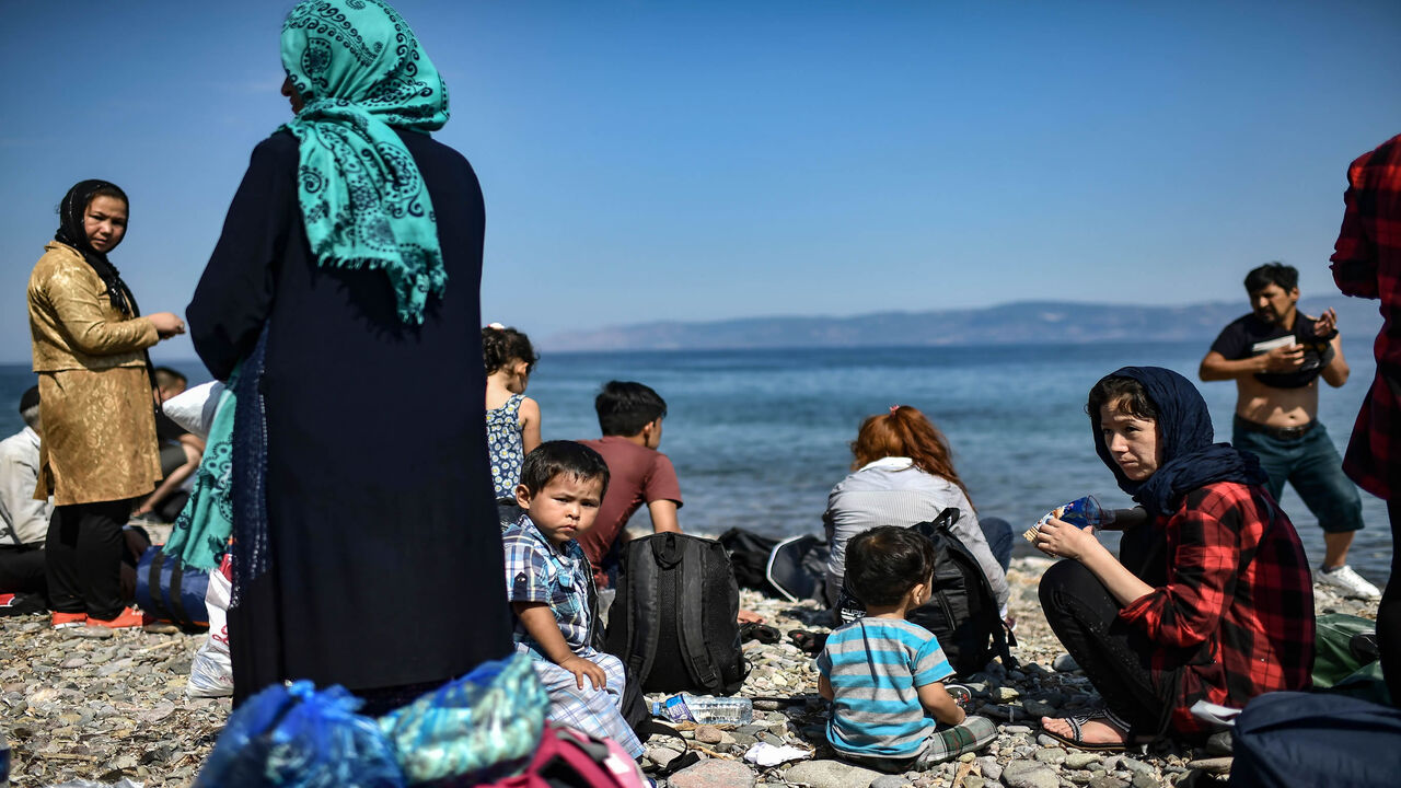 Migrants from Afghanistan arrive after crossing the Aegean Sea from Turkey with a dinghy on the Greek Mediterranean island of Lesbos, Greece, Aug. 6, 2018.
