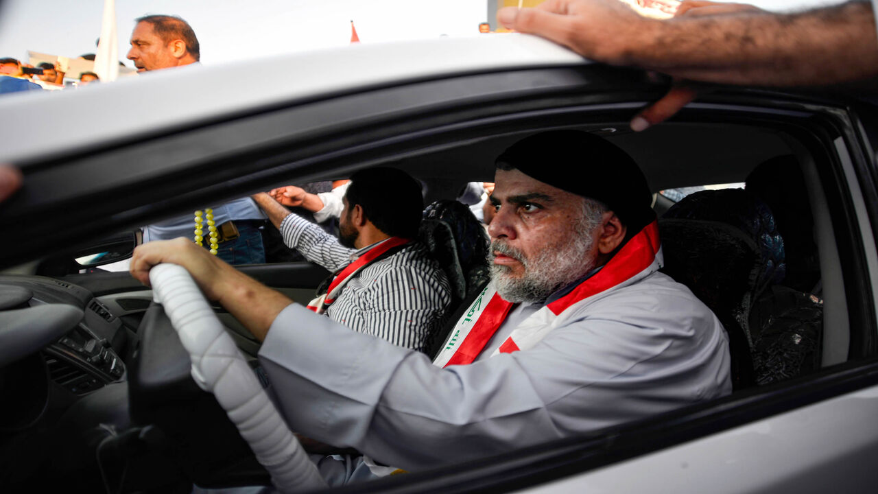 Iraqi Shiite cleric Muqtada al-Sadr (R) drives a car as he joins anti-government demonstrators gathering in the holy city of Najaf, Iraq, Oct. 29, 2019. 