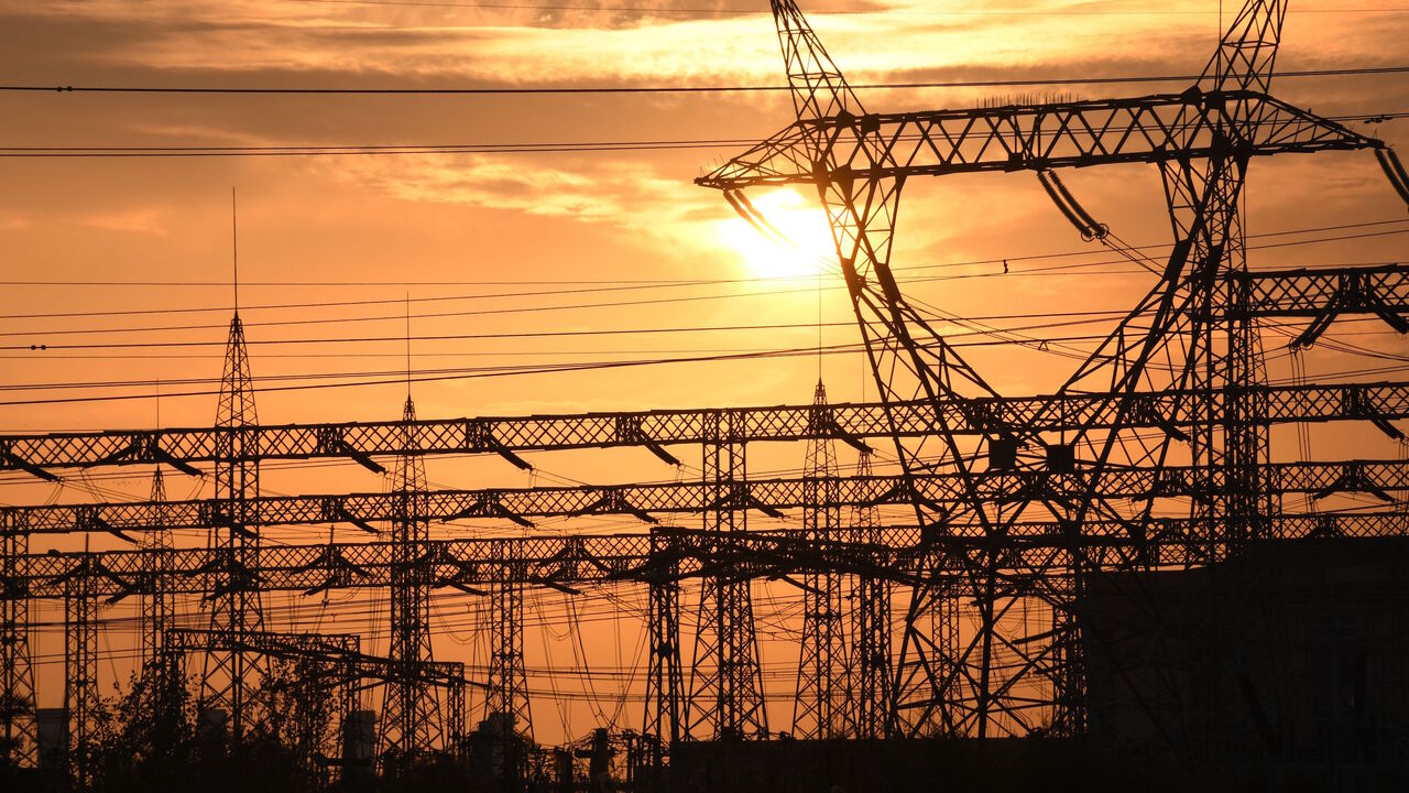 The sun sets behind electrical grids in the southern Iraqi city of Nasiriyah in the Dhi Qar province, on Jan. 3, 2021. 