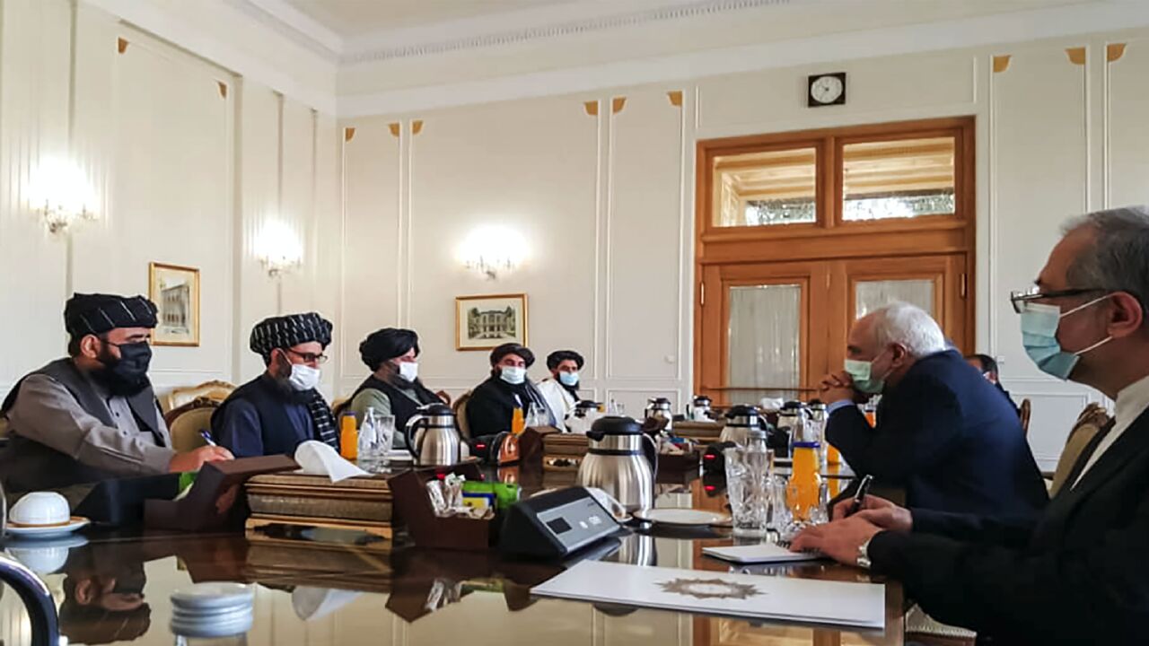 A picture obtained by AFP from the Iranian news agency Tasnim on January 31, 2021, shows Iran's Foreign Minister Mohammad Javad Zarif (R) meeting with Mullah Abdul Ghani Baradar (C) of the Taliban in Tehran.