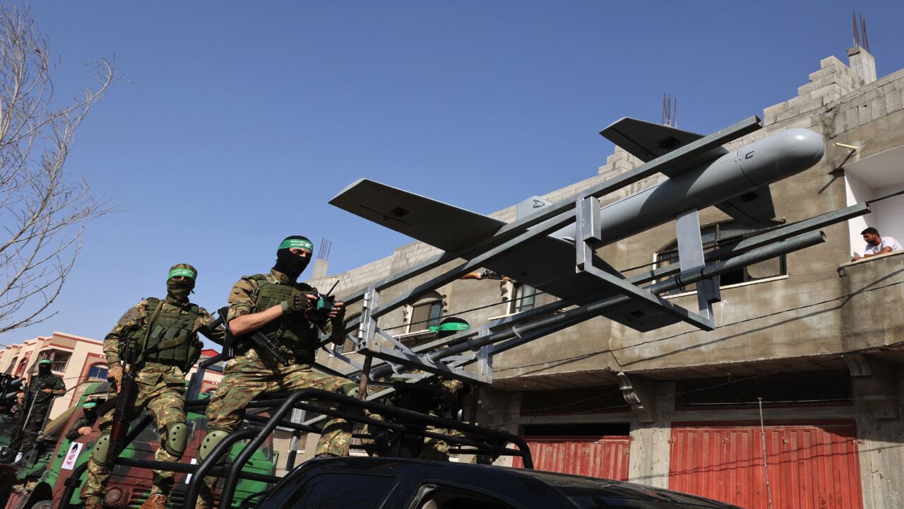 Members of Izz ad-Din al-Qassam Brigades, the armed wing of the Palestinian Hamas movement, parade with a drone in Rafah in the southern Gaza Strip on May 28, 2021.