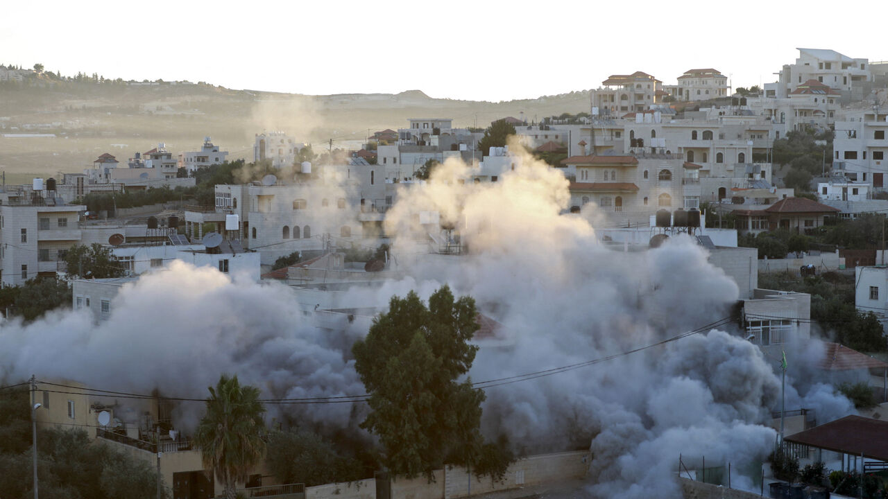 A building that belonged to Palestinian Montasser Shalaby, who was arrested in May on suspicion of carrying out a drive-by shooting attack, is imploded in the course of its demolition by Israeli forces in the village of Turmus'ayya near Ramallah in the occupied West Bank on July 8, 2021.
