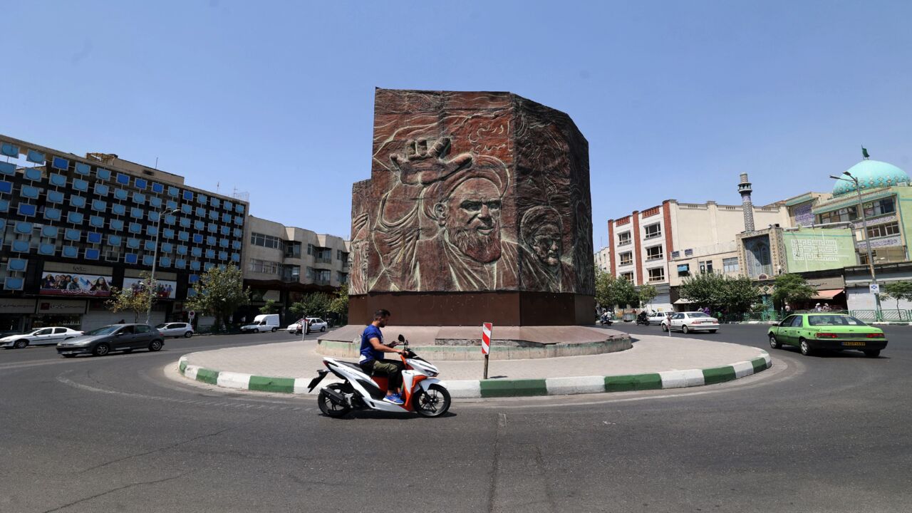 An Iranian man rides a motorbike at Enghelab Square in the center of the capital, Tehran, on July 20, 2021, as authorities tighten restrictions amid the COVID-19 pandemic.