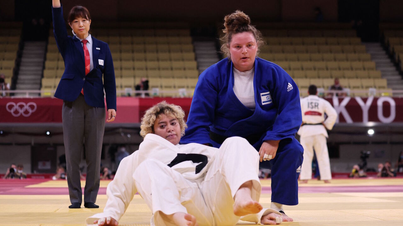 Israel's Raz Hershko (blue) and Saudi Arabia's Tahani Alqahtani compete in the judo women's +78kg elimination round bout during the Tokyo 2020 Olympic Games at the Nippon Budokan in Tokyo on July 30, 2021.