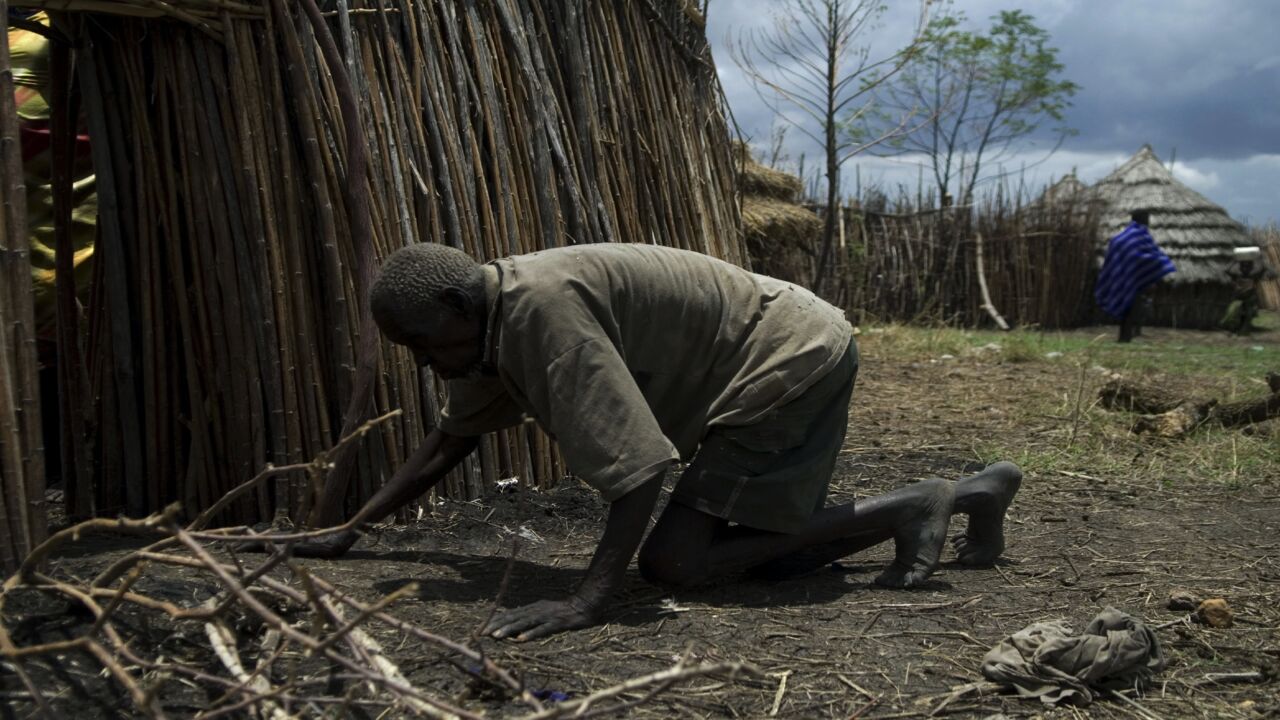 Lochaun John, who suffers from severe undernourishment, crawls into his hut in Lokupoi village, Moroto, Uganda, on March 28, 2008.  