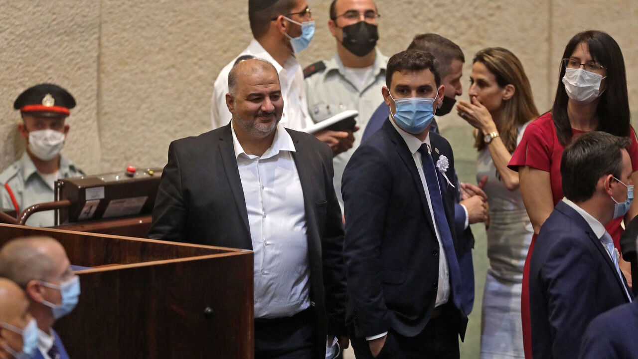 Mansour Abbas (L), head of Israel's conservative Islamic Raam party, attends a Knesset (Parliament) meeting in Jerusalem on July 7, 2021, during which Israeli President-elect Yitzhak Herzog will swear allegiance.