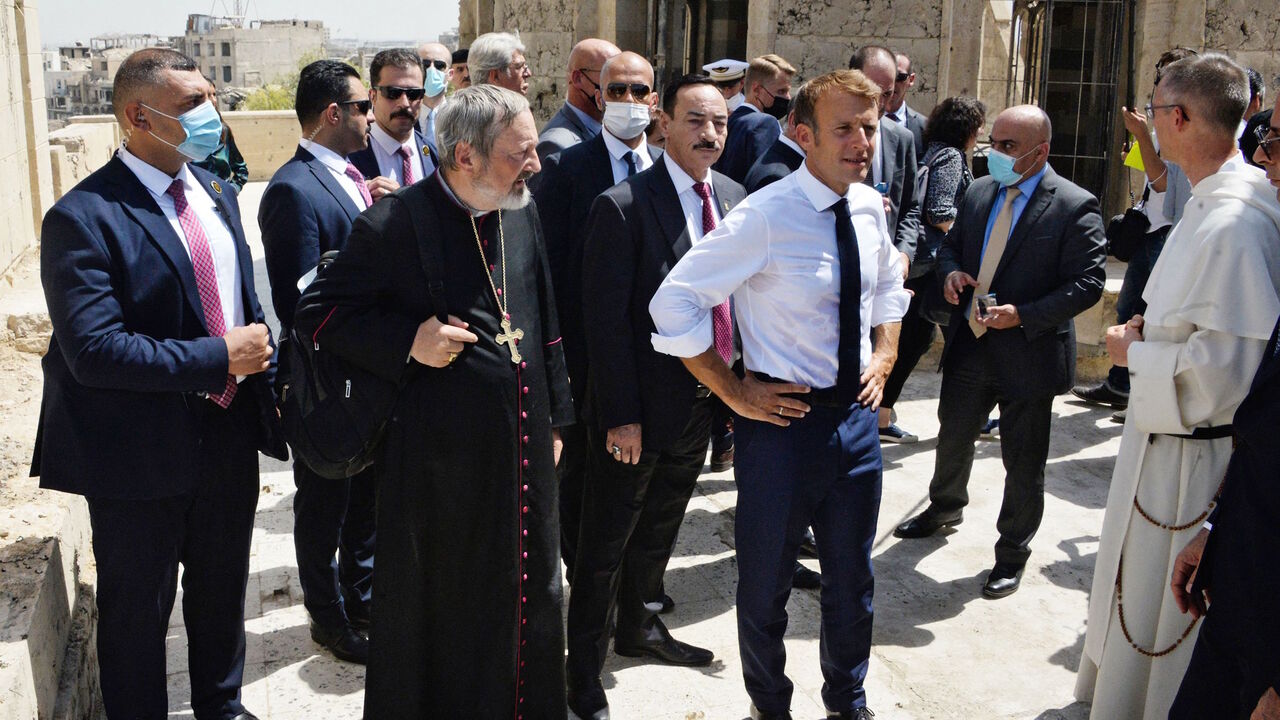 French President Emmanuel Macron (C-R) tours the Our Lady of the Hour Church in Iraq's second city of Mosul, in the northern Nineveh province, on Aug. 29, 2021.