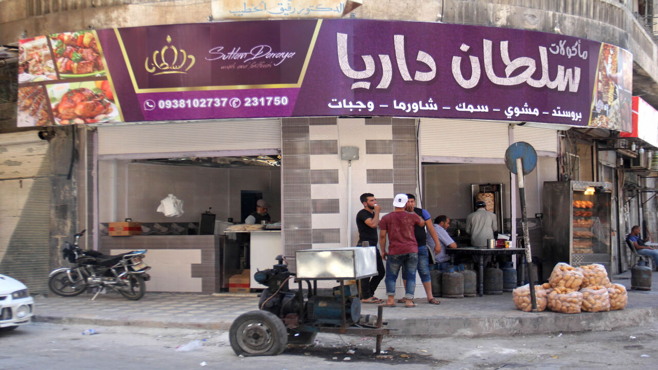 A general view shows men standing outside the Sultan Daraya restaurant in the rebel-controlled northern city of Idlib, Syria, July 1, 2017. 