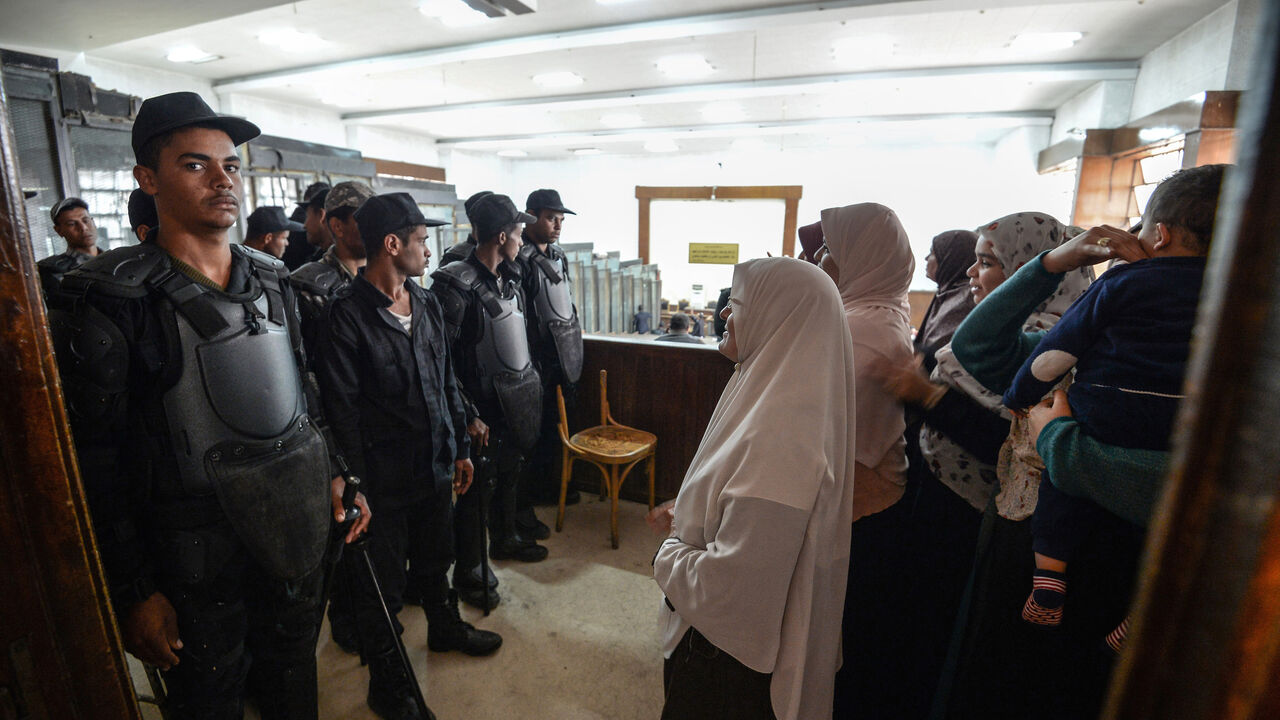 Relatives of members of the Muslim Brotherhood under trial attend a court session for them and former Egyptian president Mohamed Morsi who was ousted in 2013, at a make-shift courthouse in southern Cairo on Dec. 2, 2018.