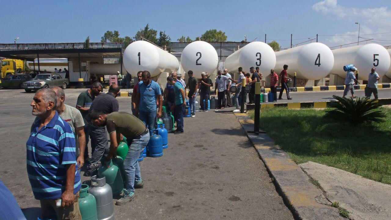 Lebanese wait to fill their gas cylinders in the southern city of Sidon amidst a deepening economic crisis, on Aug. 10, 2021. 