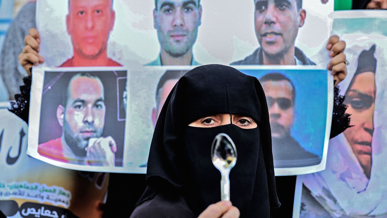 A demonstrator holds up a spoon, reportedly the digging tool used by six Palestinian prisoners who escaped from Israel's Gilboa prison, during a rally in solidarity with them in Khan Yunis in the southern Gaza Strip on Sept. 8, 2021.