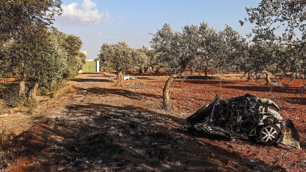 This picture taken on Sept. 20, 2021 shows a view of vehicle destroyed by what is believed to be a drone strike, on the northeastern outskirts of Syria's rebel-held northwestern city of Idlib. 