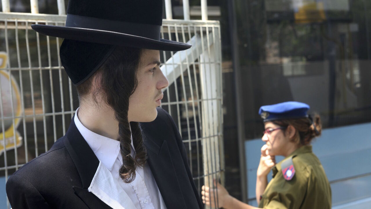 A religious Jewish yeshiva (seminary) student stands outside the local army draft office May 11, 2006 at Tel Hashomer near Tel Aviv in central Israel. 