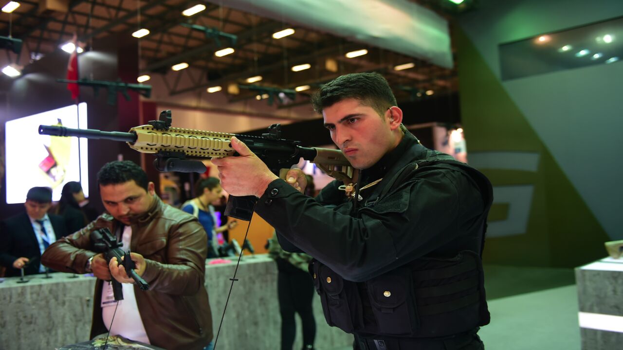 People look at military weapons on May 9, 2017, during the opening day of the 13th International Defense Industry Fair in Istanbul.