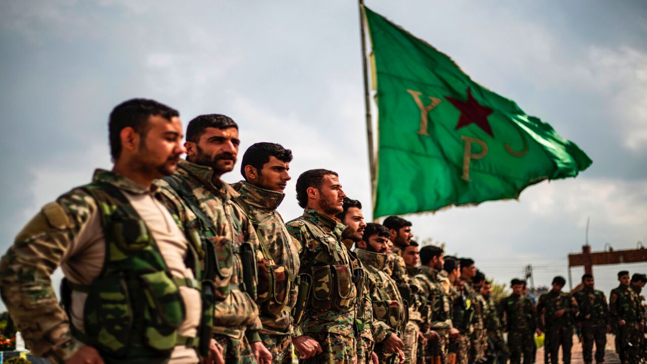 Members of the Kurdish-led Syrian Democratic Forces (SDF) attend the funeral of an Arab fighter.