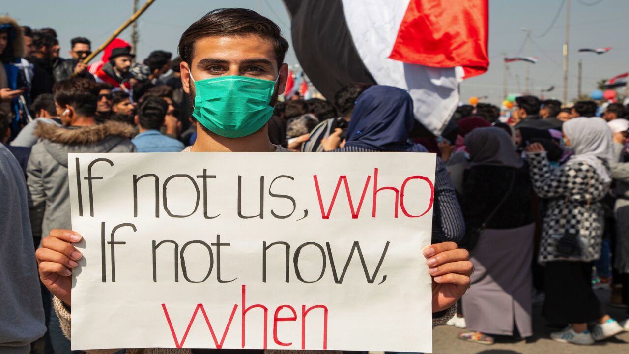 An Iraqi demonstrator holds a placard during an anti-government demonstration by Basra University students in the southern city of Basra, on Feb. 11, 2020.