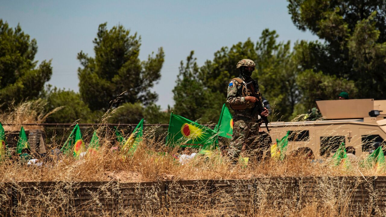 A member of security of the Syrian Democratic Forces (SDF) stands guard in the countryside of the Hasakah province, on June 27, 2020.