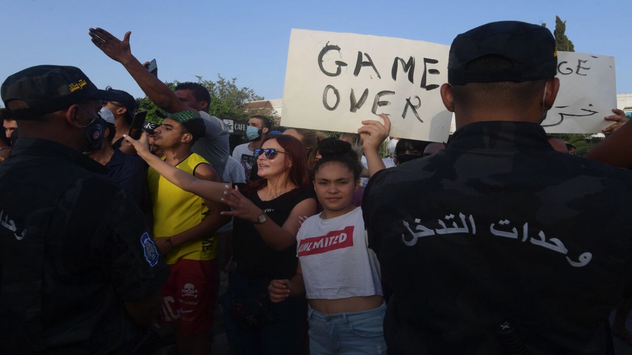 Supporters of Tunisian President Kais Saied chant slogans.