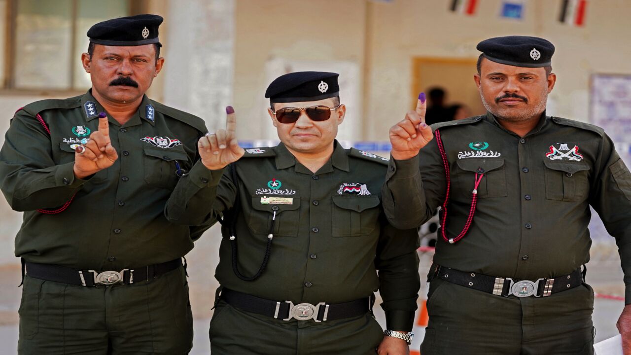 Members of Iraq's security forces take part in early voting for the parliamentary elections in the central city of Najaf, on Oct. 8, 2021. 