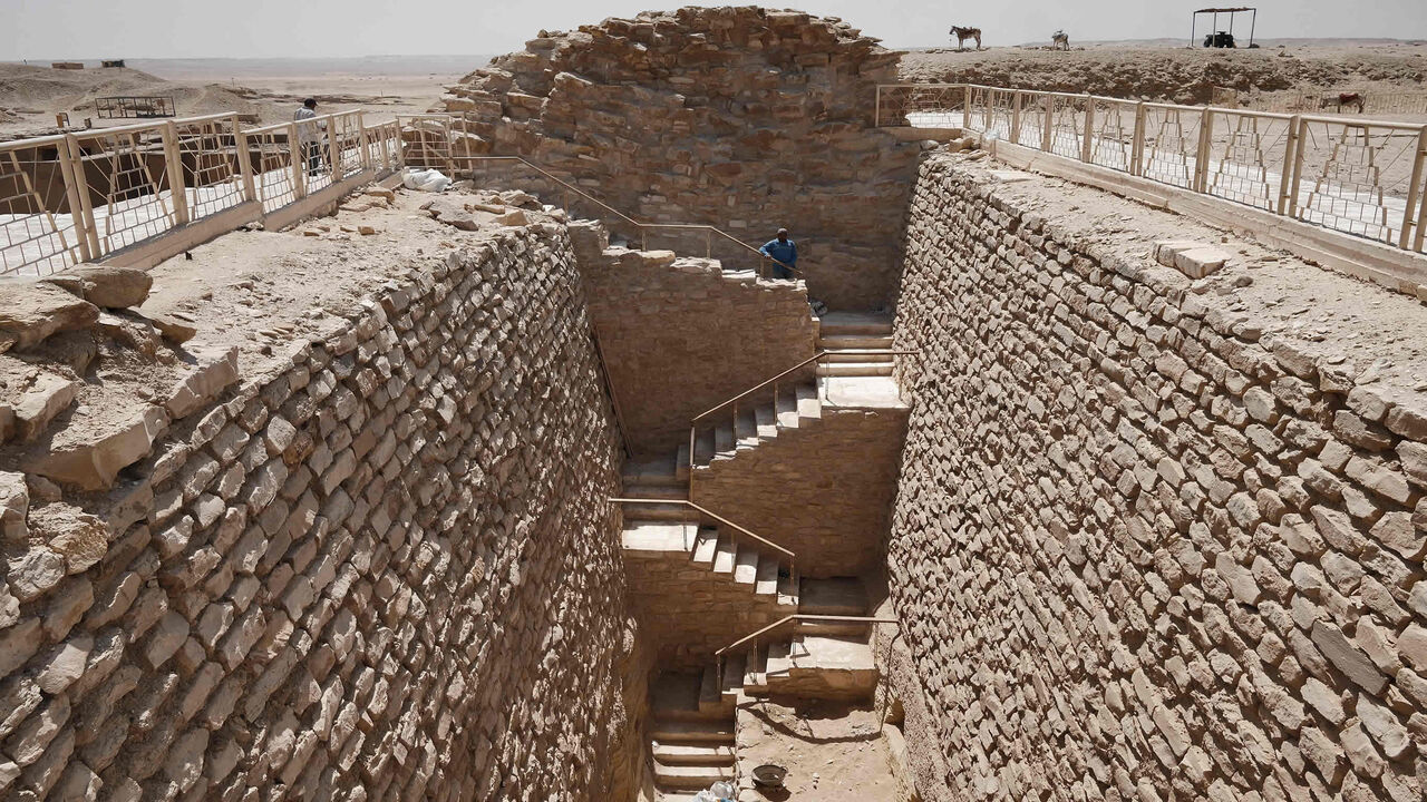 A workman stands along the steps leading to the southern tomb near the step pyramid of the third dynasty Pharaoh Djoser (27th century B.C.), at at the Saqqara Necropolis, Egypt, May 27, 2021.