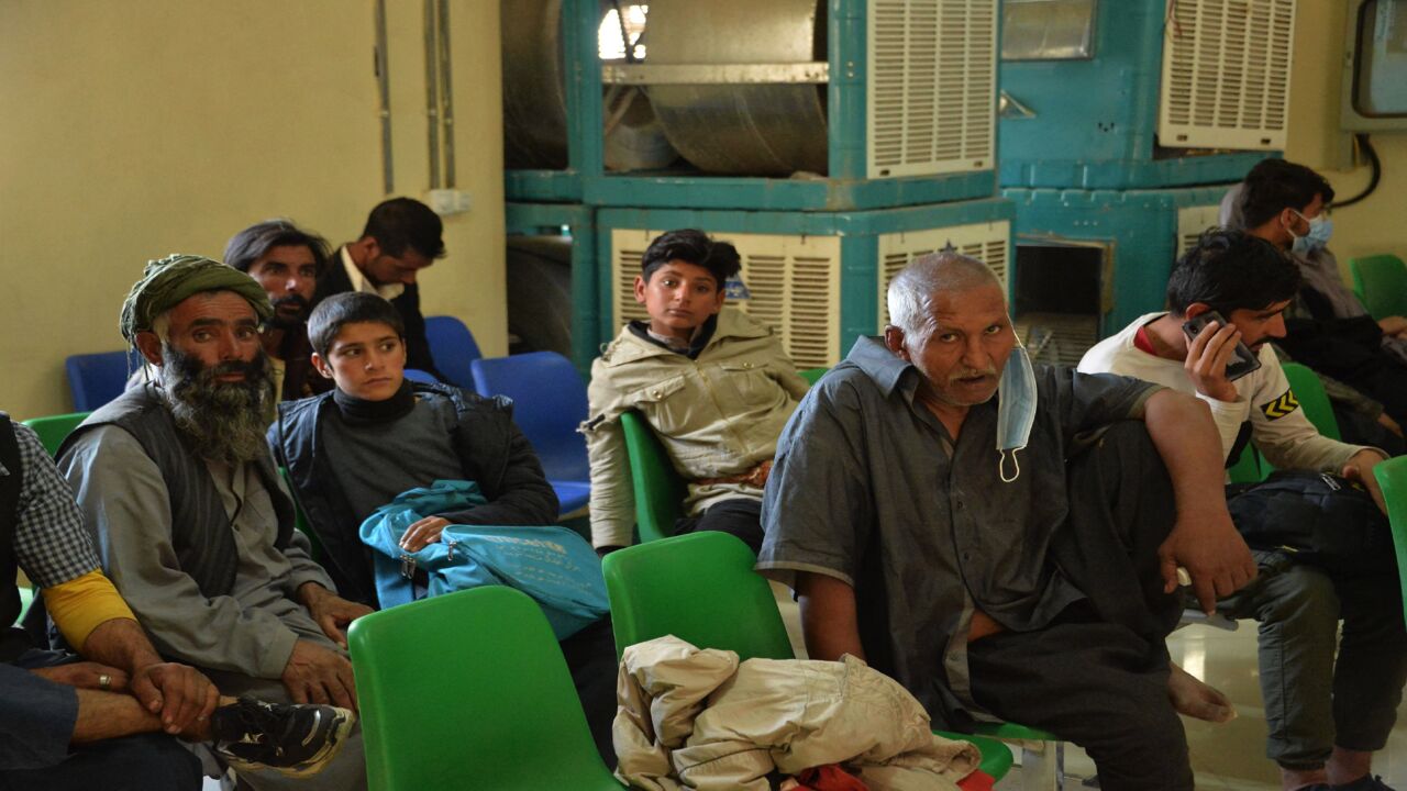 In this picture taken on Oct. 19, 2021, Afghans who were forcibly deported back from Iran to Afghanistan wait in a refugee office at the border between Afghanistan and Iran.