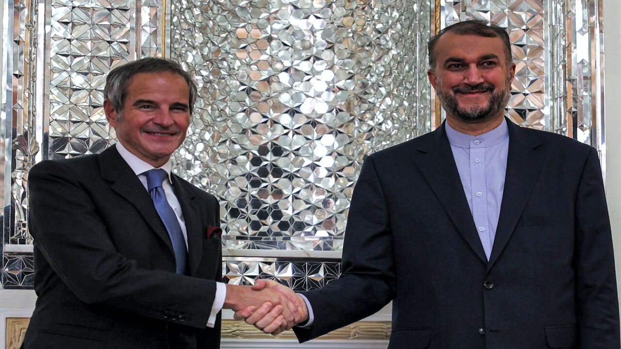 (R to L) Iran's Foreign Minister Hossein Amir-Abdollahian shakes hands with Director-General of the International Atomic Energy Agency (IAEA) Rafael Grossi.