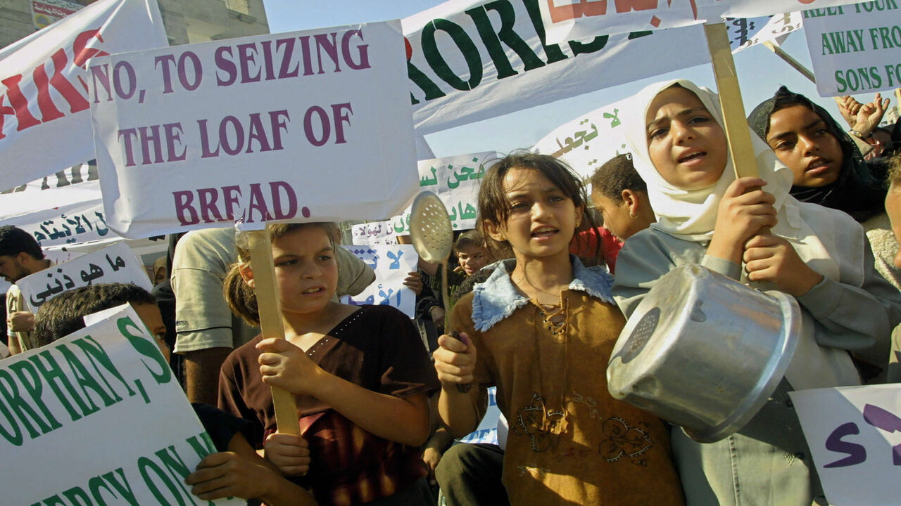 Palestinian children demonstrate against the Palestinian Authority's decision to freeze some bank accounts linked to Islamic organizations, Rafah refugee camp, Gaza Strip, Aug. 28, 2003.