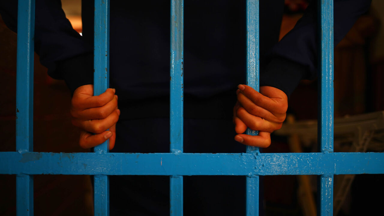 A drug addict stands behind bars at a Hamas-run prison in Gaza City, Gaza Strip, May 10, 2017.