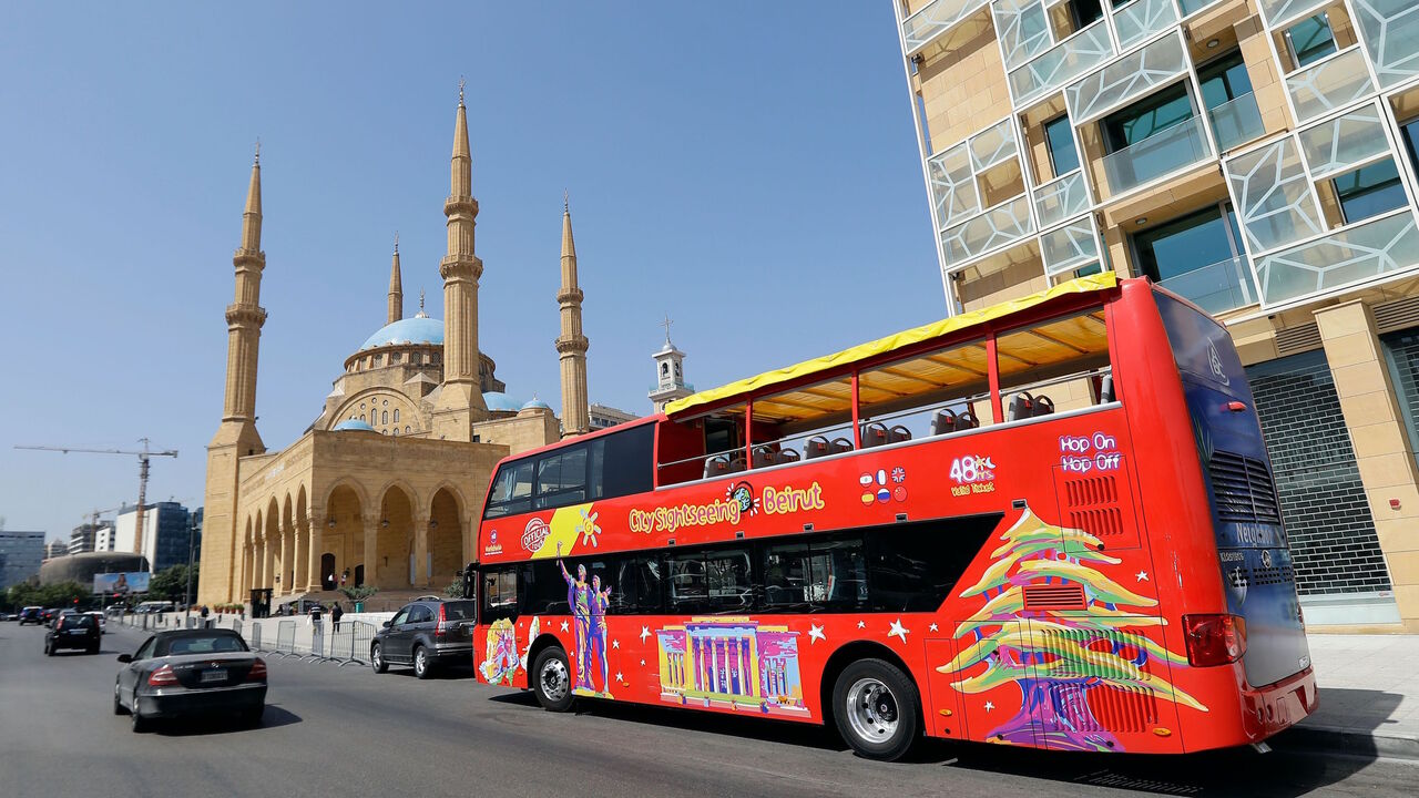 A city sightseeing bus is pictured parked outside Beirut's landmark Mohammad al-Amin mosque on May 20, 2019. 