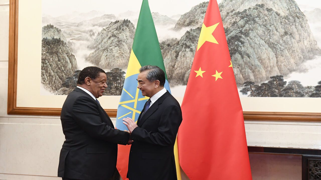 Chinese Foreign Minister Wang Yi (R) shakes hands with former Ethiopian President Mulatu Teshome during a meeting at the Diaoyutai State Guesthouse, Beijing, China, Oct. 30, 2019.