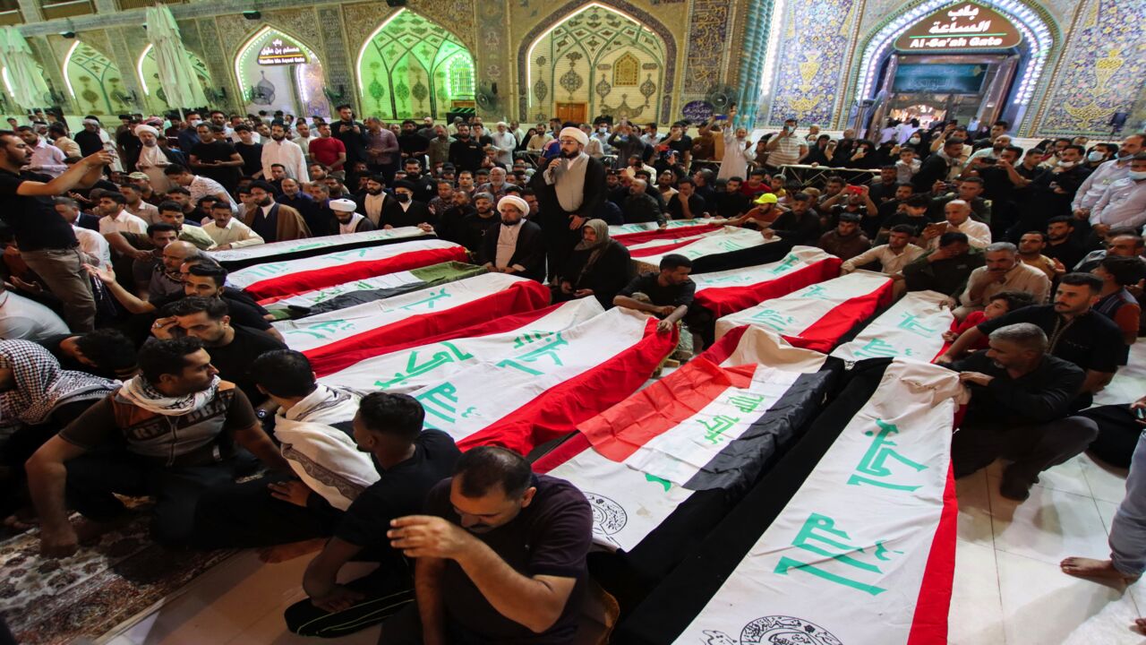 Mourners on Oct. 27, 2021, surround caskets of victims of yesterday's IS attack on the village of Al-Rashad in Iraq's eastern Diyala province.