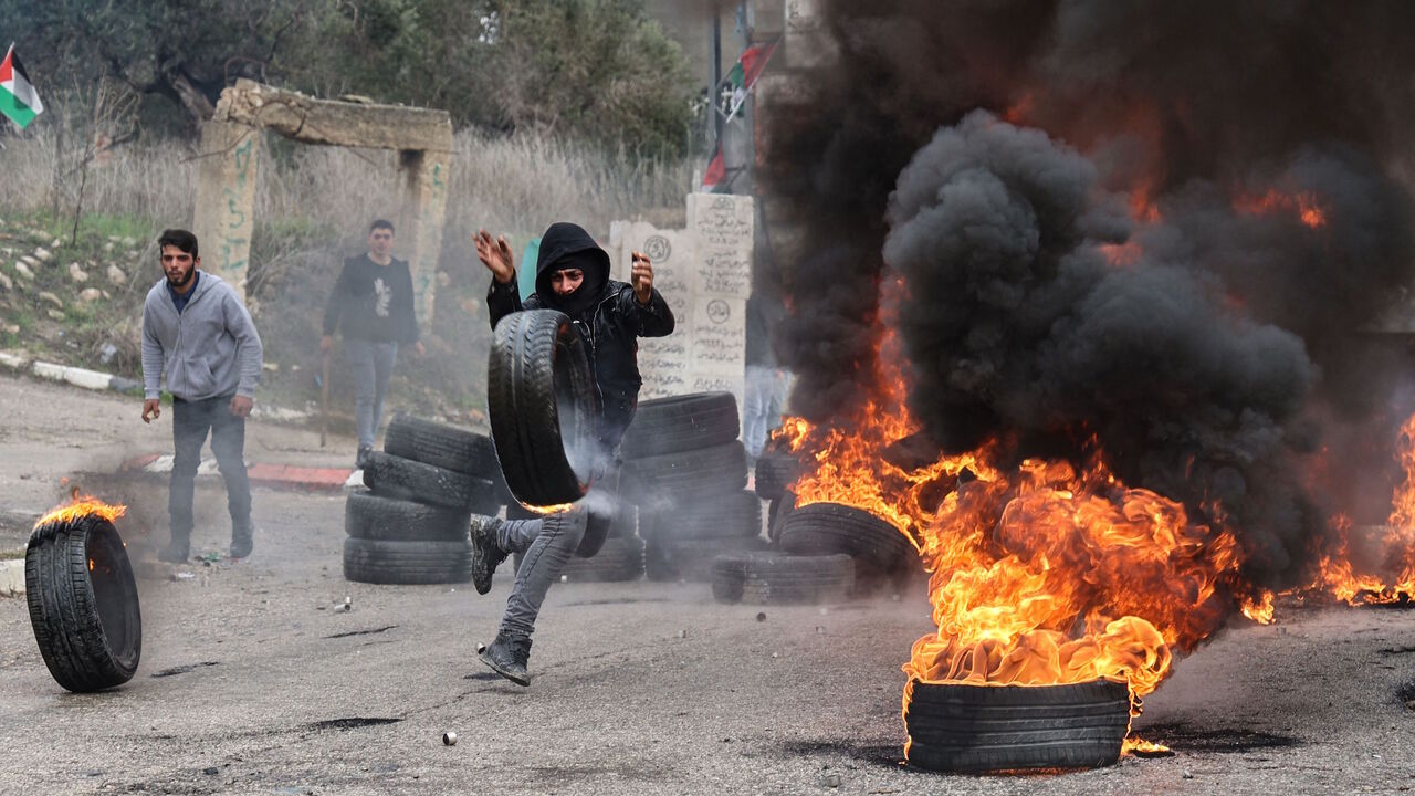 Palestinians protesting against the return of Jewish settlers to their area, confront members of the Israeli security forces, in the occupied-West Bank village of Burqah, near the illegal Israeli outpost of Homesh, on Dec. 23, 2021.