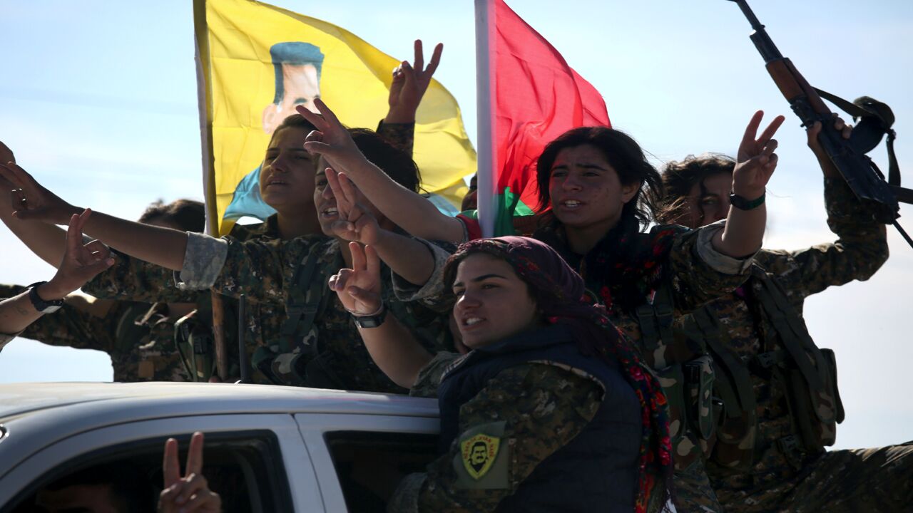 Yazidi soldiers cheer a fallen comrade on Nov. 15, 2015, near Sinjar, Iraq.