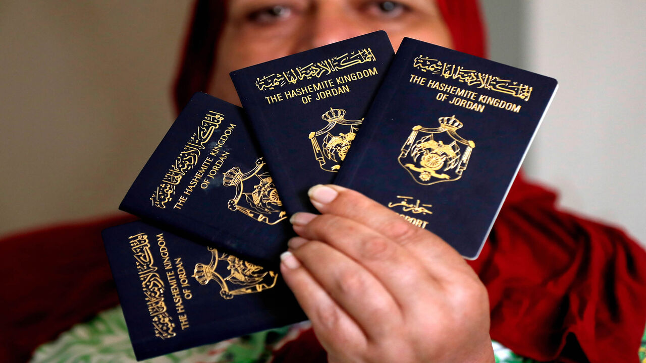 A Palestinian woman shows Jordanian passports in the Palestinian neighborhood of Beit Hanina in East Jerusalem, Aug. 5, 2019.