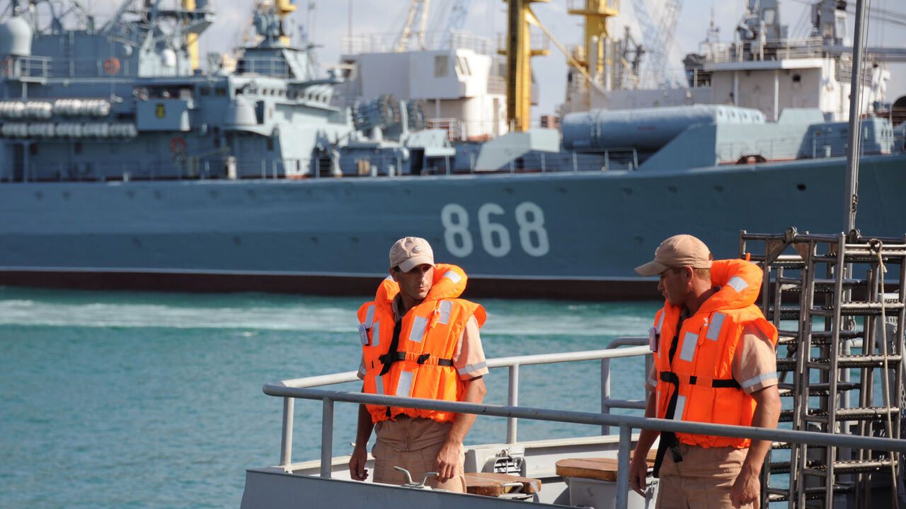 Russian soldiers stand aboard a ship at the Russian naval base in the Syrian Mediterranean port of Tartus on Sept. 26, 2019. 