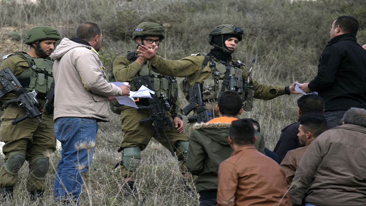 Israeli soldiers scuffle with Palestinians in the village of Burqa, northwest of the city of Nablus, following a weekly demonstration against the expropriation of Palestinian land by Israel, West Bank, Dec. 13, 2019.