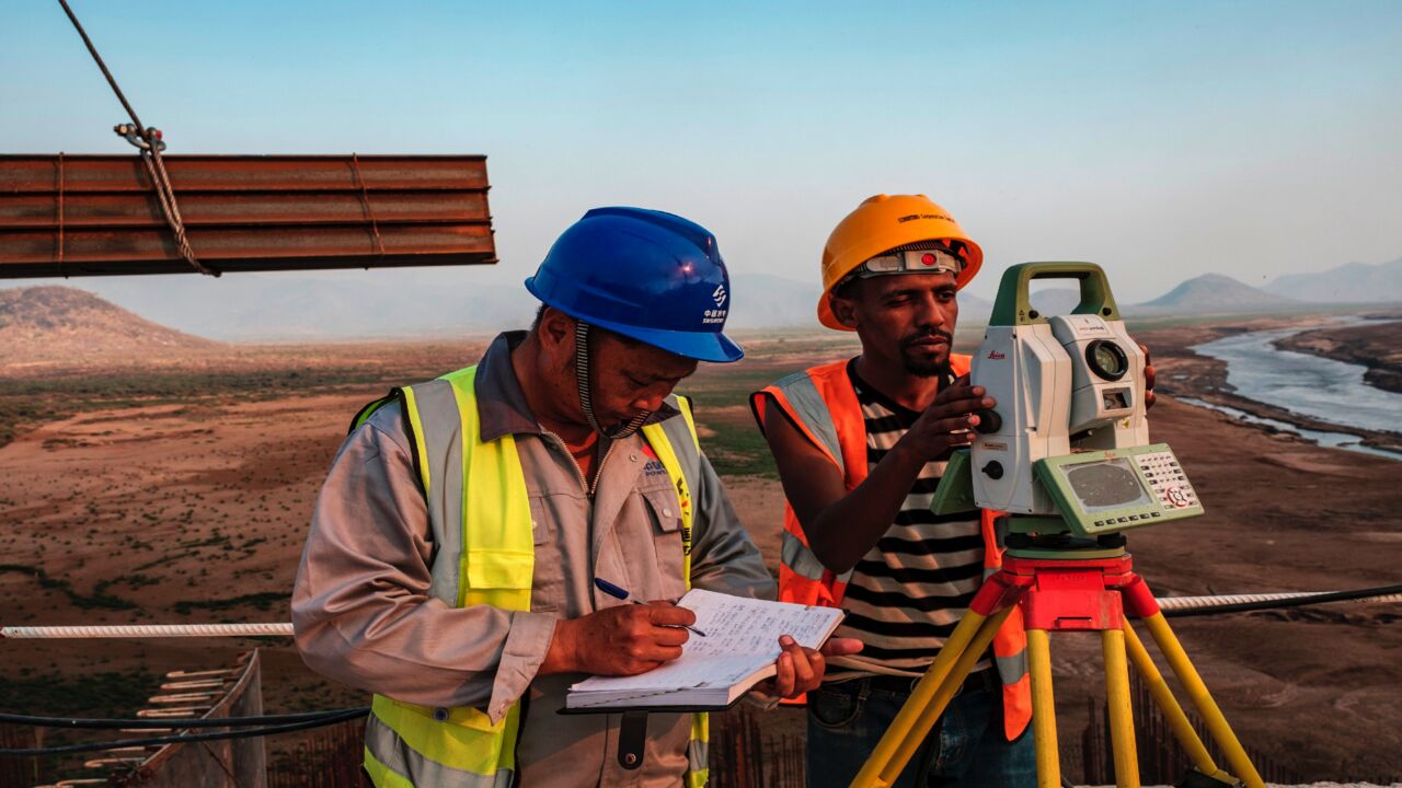 Workers perform measurements at the Grand Ethiopian Renaissance Dam near Guba in Ethiopia, on Dec. 26, 2019.