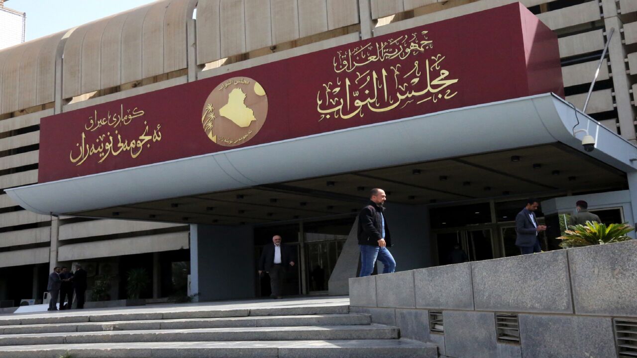 Iraqis stand outside the parliament building, or Council of Representatives, in Baghdad's Green Zone on Feb. 27, 2020.