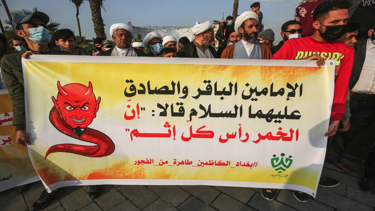 Shiite Muslim clerics march with a banner saying that alcohol is the root of all sin, during a demonstration in Baghdad on Dec. 3, 2020.