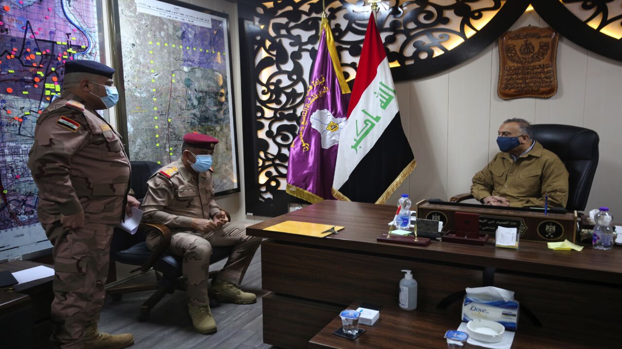 Iraq's Prime Minister Mustafa al-Kadhimi (R) visits the army headquarters in Tarmiya, 35 kilometers north of Baghdad, on Feb. 20, 2021.