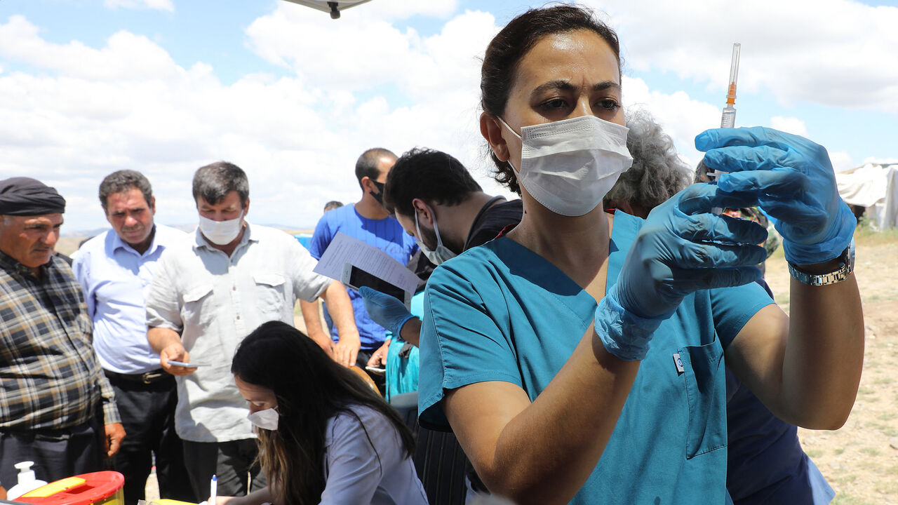 A nurse prepares a syringe with the Sinovac's COVID-19 coronavirus vaccine during a vaccination campaign in the village of Oguzlar, a hundred of kilometres away from Ankara on July 8, 2021. 