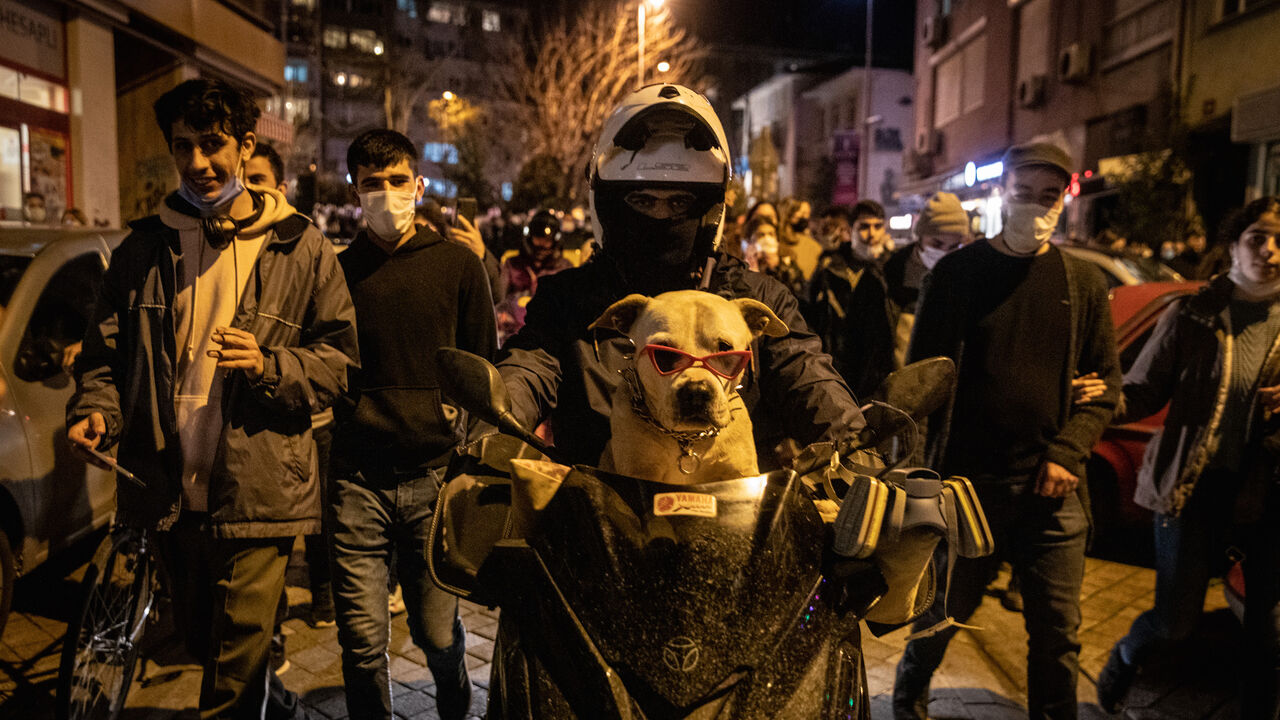 A protester rides a motorbike with his dog during a protest against the appointment of new Bogazici University rector Melih Bulu in the Kadikoy district on Feb. 2, 2021 in Istanbul Turkey. 