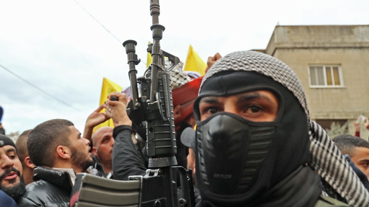A member of the Fatah movement attends the funeral on February 14, 2022 for Palestinian teenager Mohammed Abu Salah, 17, killed after Israeli forces entered a village near the flashpoint town of Jenin in the occupied West Bank A member of the Fatah movement attends the funeral on February 14, 2022 for Palestinian teenager Mohammed Abu Salah, 17, killed after Israeli forces entered a village near the flashpoint town of Jenin in the occupied West Bank