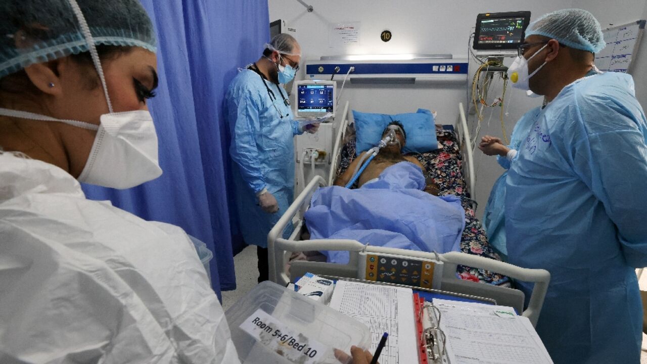 Iraqi medical workers check on a patient at the coronavirus ward of Al-Shifaa Hospital in the capital Baghdad Iraqi medical workers check on a patient at the coronavirus ward of Al-Shifaa Hospital in the capital Baghdad