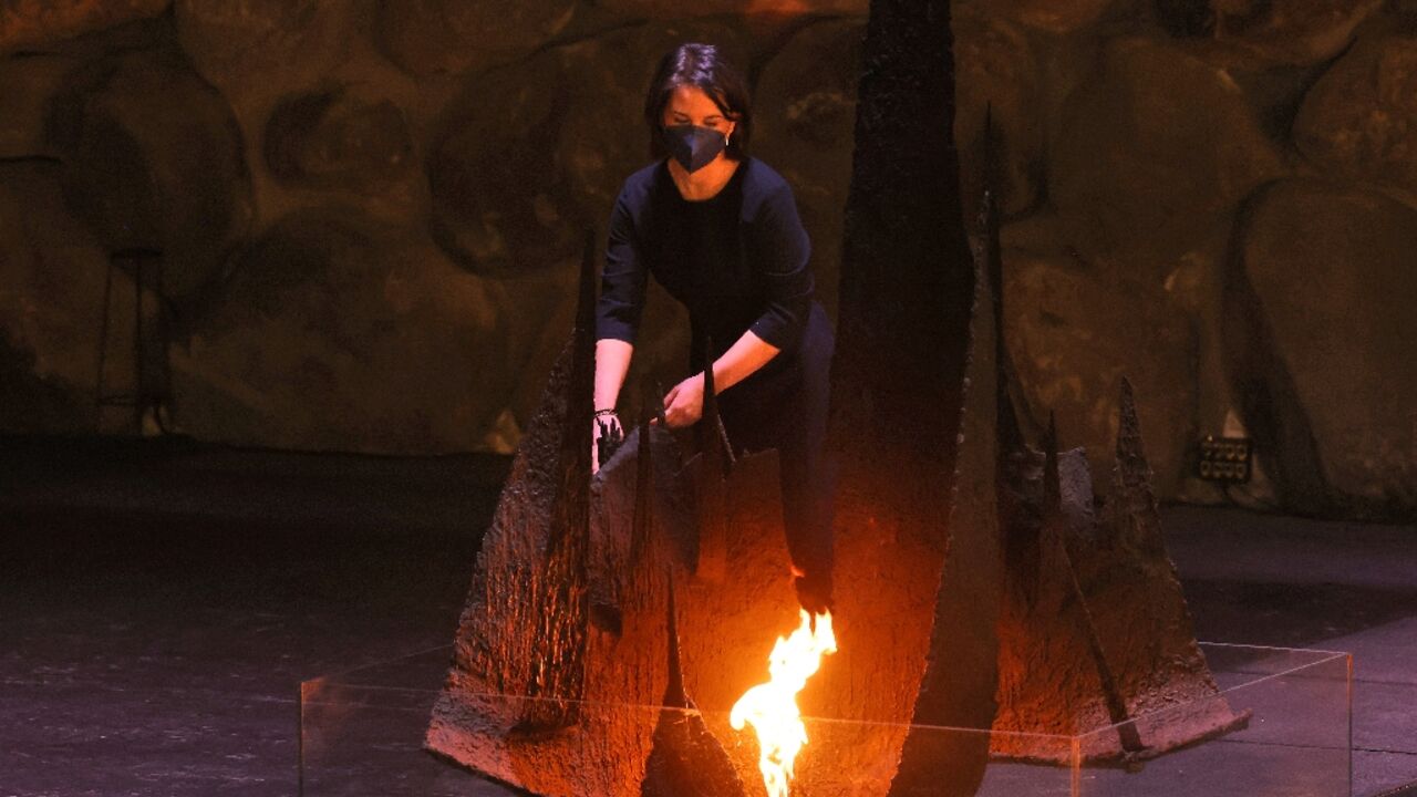 German Foreign Minister Annalena Baerbock rekindles the eternal flame at the Hall of Remembrance during her visit to the Yad Vashem Holocaust Memorial museum in Jerusalem